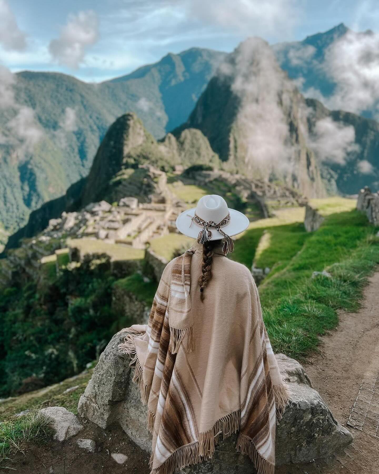 Famous postcard view of Machu Picchu ruins and surrounding mountains